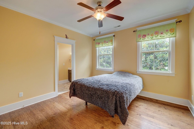 7406 Songbird Ct, Wilmington, NC 28411 - bedroom with crown molding, multiple windows, light wood-style floors, and baseboards