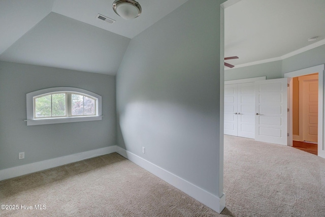 7406 Songbird Ct, Wilmington, NC 28411 - empty room featuring carpet flooring, baseboards, ceiling fan, vaulted ceiling, and a smoke detector