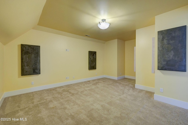 7406 Songbird Ct, Wilmington, NC 28411 - spare room featuring carpet, baseboards, and lofted ceiling