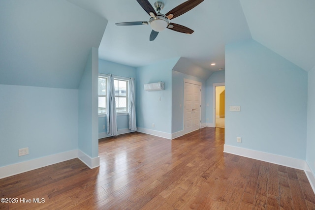 7406 Songbird Ct, Wilmington, NC 28411 - bonus room featuring a wall mounted AC, ceiling fan, lofted ceiling, baseboards, and wood finished floors