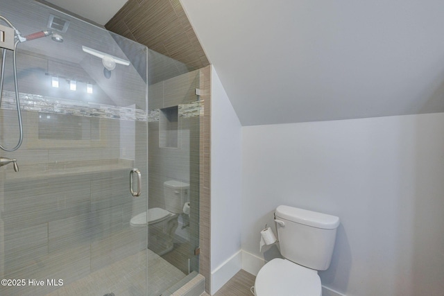 7406 Songbird Ct, Wilmington, NC 28411 - bathroom with toilet, a stall shower, baseboards, and lofted ceiling