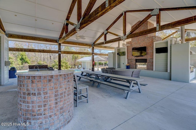 7406 Songbird Ct, Wilmington, NC 28411 - view of patio featuring a gazebo, an outdoor kitchen, and an outdoor brick fireplace