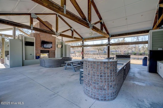 7406 Songbird Ct, Wilmington, NC 28411 - view of patio with a gazebo, exterior kitchen, an outdoor bar, and an outdoor living space with a fireplace