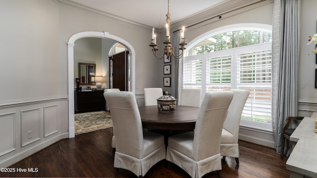 370 Lake Dornoch Dr, Pinehurst, NC 28374 - dining space with a chandelier, ornamental molding, dark wood-type flooring, arched walkways, and wainscoting