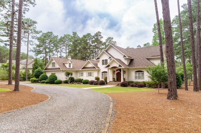 370 Lake Dornoch Dr, Pinehurst, NC 28374 - view of front of property with curved driveway, a shingled roof, and a chimney