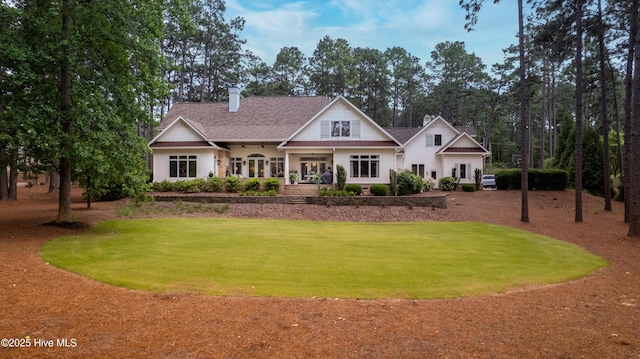 370 Lake Dornoch Dr, Pinehurst, NC 28374 - view of front facade featuring a front yard, a chimney, and roof with shingles