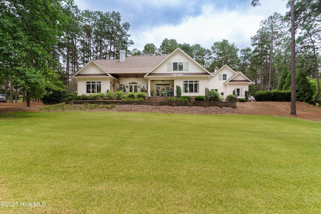 370 Lake Dornoch Dr, Pinehurst, NC 28374 - view of front of property with a front yard, a chimney, and roof with shingles