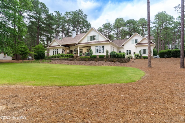 370 Lake Dornoch Dr, Pinehurst, NC 28374 - view of front of house with a chimney, a front yard, and roof with shingles