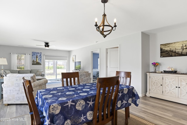 940 Pine Needles Rd, Southport, NC 28461 - dining space with a chandelier, wood finished floors, a ceiling fan, and baseboards
