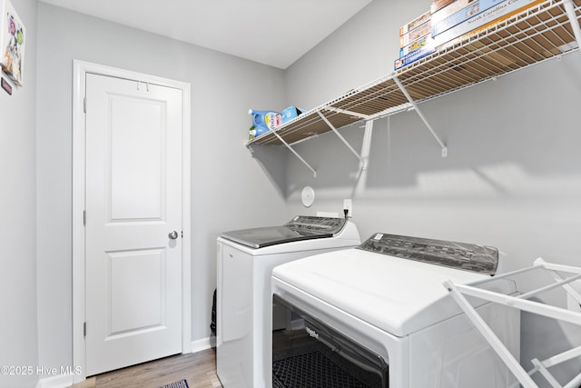 940 Pine Needles Rd, Southport, NC 28461 - laundry area with washer and dryer, light wood-style floors, and baseboards