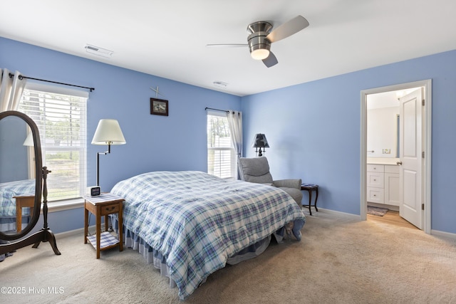 940 Pine Needles Rd, Southport, NC 28461 - bedroom with light colored carpet, baseboards, ensuite bathroom, and a ceiling fan