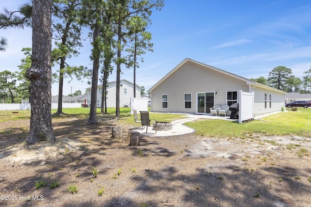 940 Pine Needles Rd, Southport, NC 28461 - rear view of house with a patio and a yard