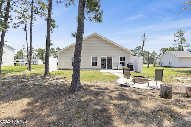 940 Pine Needles Rd, Southport, NC 28461 - rear view of property with an outdoor fire pit, a yard, and a patio