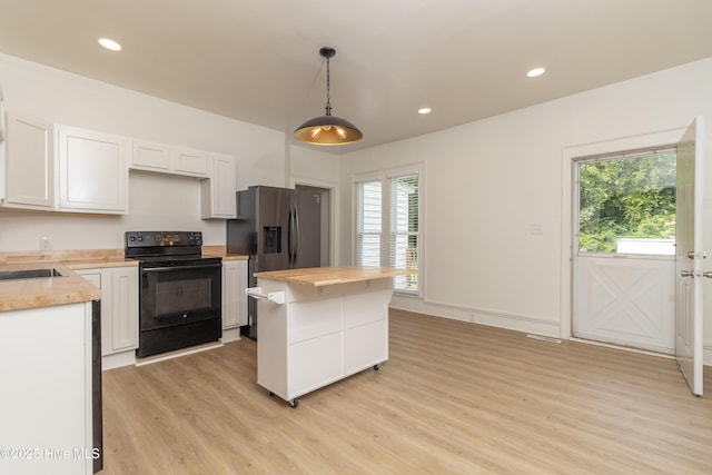 502 Sterlingworth St, Windsor, NC 27983 - kitchen featuring black range with electric stovetop, light wood-type flooring, butcher block counters, healthy amount of natural light, and recessed lighting