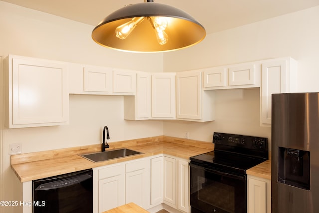 502 Sterlingworth St, Windsor, NC 27983 - kitchen featuring black appliances, wood counters, a sink, and white cabinets