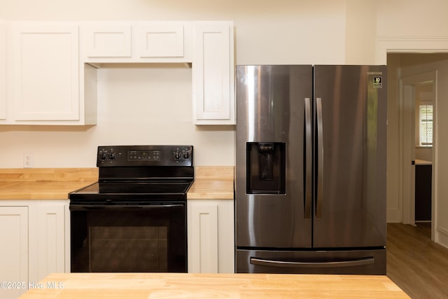 502 Sterlingworth St, Windsor, NC 27983 - kitchen featuring stainless steel fridge with ice dispenser, butcher block countertops, black range with electric stovetop, white cabinets, and wood finished floors