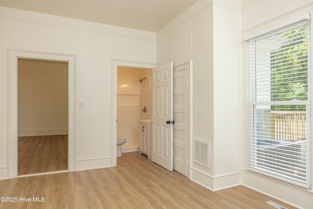 502 Sterlingworth St, Windsor, NC 27983 - unfurnished bedroom featuring light wood-style floors, multiple windows, and ensuite bathroom
