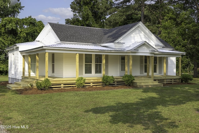 502 Sterlingworth St, Windsor, NC 27983 - farmhouse featuring a porch, a front yard, metal roof, and roof with shingles