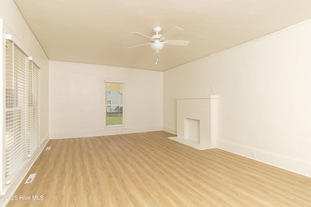502 Sterlingworth St, Windsor, NC 27983 - unfurnished living room featuring light wood-style floors, a ceiling fan, baseboards, and a brick fireplace