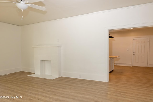 502 Sterlingworth St, Windsor, NC 27983 - unfurnished living room featuring ceiling fan, light wood-style flooring, baseboards, and a brick fireplace