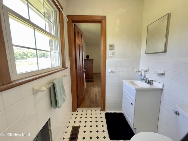 5 Keys Cross Rd, Hobbsville, NC 27946 - half bath with tile walls, vanity, plenty of natural light, wainscoting, and toilet
