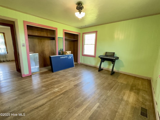 5 Keys Cross Rd, Hobbsville, NC 27946 - unfurnished bedroom featuring wood finished floors, baseboards, and multiple closets
