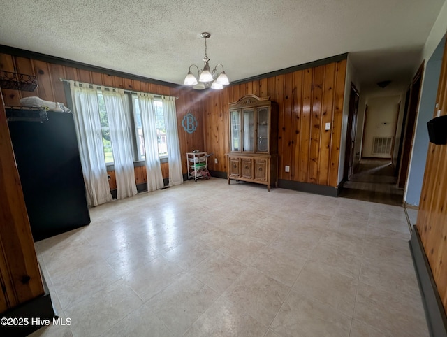 5 Keys Cross Rd, Hobbsville, NC 27946 - dining space with wood walls, a chandelier, and a textured ceiling