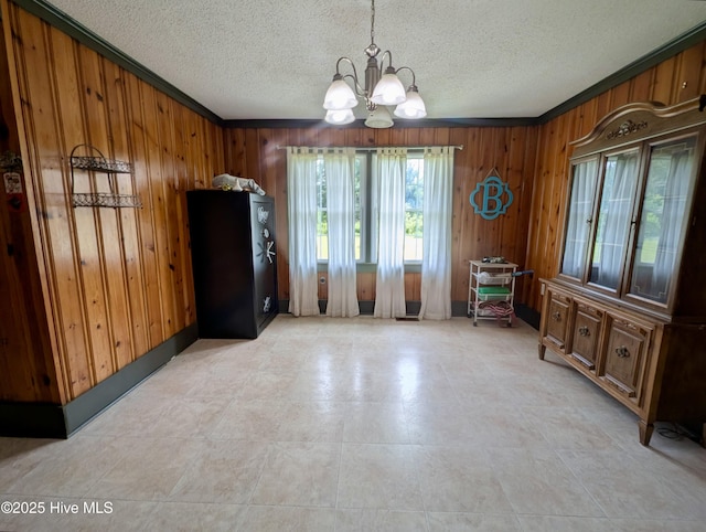 5 Keys Cross Rd, Hobbsville, NC 27946 - dining space featuring a chandelier, wooden walls, a textured ceiling, and ornamental molding