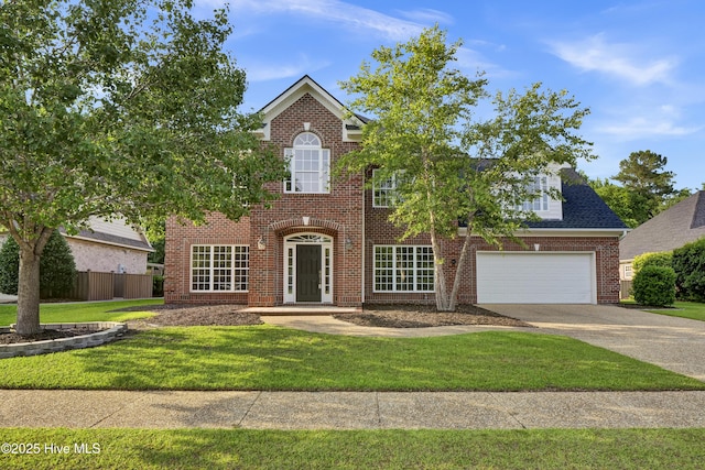1113 Foxbow Cv, Leland, NC 28451 - colonial house with concrete driveway, brick siding, and a garage
