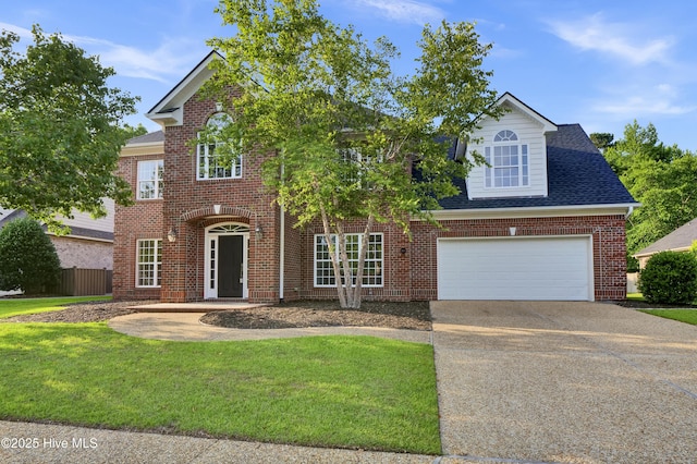 1113 Foxbow Cv, Leland, NC 28451 - view of front of home featuring driveway, brick siding, an attached garage, and roof with shingles