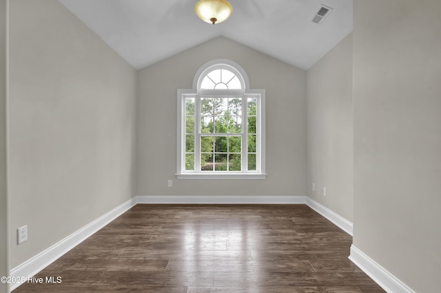 1113 Foxbow Cv, Leland, NC 28451 - empty room featuring dark wood-style flooring, vaulted ceiling, and baseboards