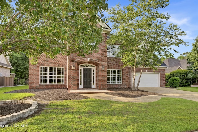 1113 Foxbow Cv, Leland, NC 28451 - view of front facade featuring driveway, brick siding, and a garage