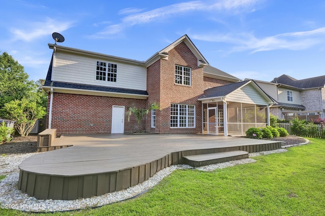 1113 Foxbow Cv, Leland, NC 28451 - rear view of house featuring a sunroom, brick siding, a wooden deck, and a shingled roof
