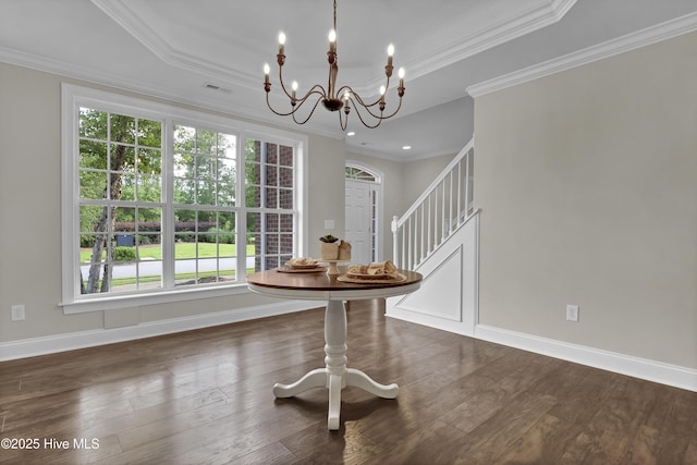1113 Foxbow Cv, Leland, NC 28451 - dining area featuring a chandelier, baseboards, a tray ceiling, ornamental molding, and wood finished floors