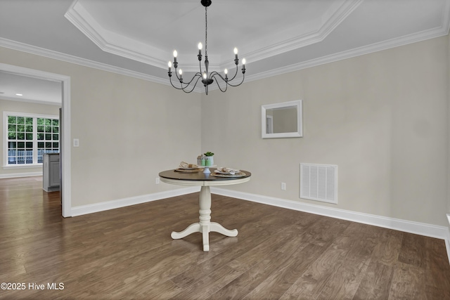 1113 Foxbow Cv, Leland, NC 28451 - unfurnished dining area featuring a tray ceiling, dark wood-type flooring, baseboards, and ornamental molding