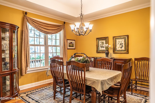 31 Pinewild Dr, Pinehurst, NC 28374 - dining room with a chandelier, plenty of natural light, ornamental molding, and wood finished floors