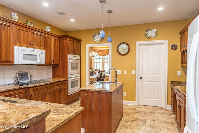 31 Pinewild Dr, Pinehurst, NC 28374 - kitchen featuring white appliances, a sink, brown cabinetry, a kitchen island with sink, and tasteful backsplash