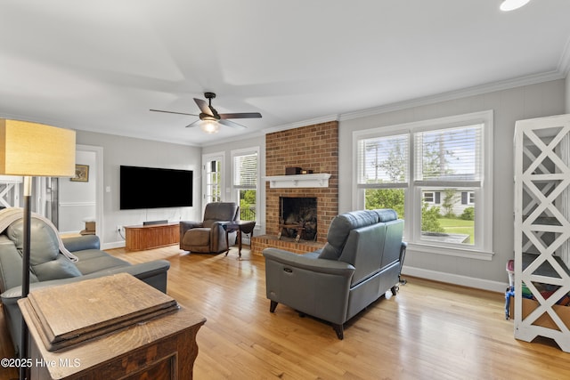 405 E Westbrook St, Wallace, NC 28466 - living room with ceiling fan, crown molding, a fireplace, light wood-style flooring, and baseboards