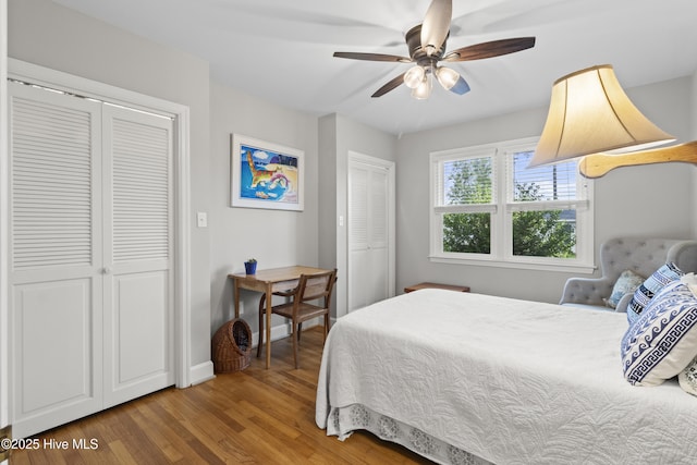 405 E Westbrook St, Wallace, NC 28466 - bedroom with wood finished floors, two closets, baseboards, and ceiling fan