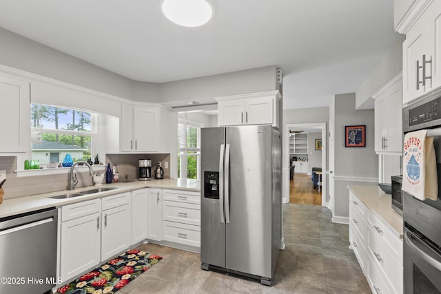 405 E Westbrook St, Wallace, NC 28466 - kitchen featuring appliances with stainless steel finishes, a sink, light countertops, and healthy amount of natural light