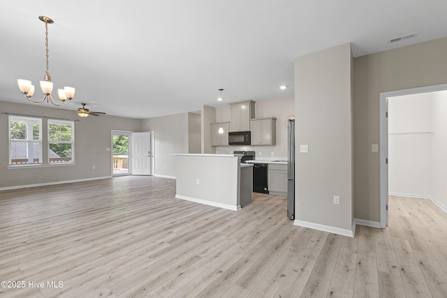 218 Spring Dr, Jacksonville, NC 28540 - kitchen featuring black microwave, gray cabinetry, open floor plan, light wood-style floors, and a chandelier