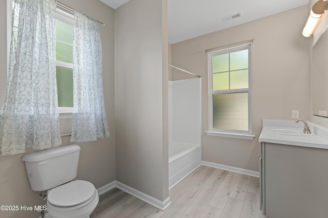 218 Spring Dr, Jacksonville, NC 28540 - bathroom with wood finished floors, toilet, vanity, and plenty of natural light