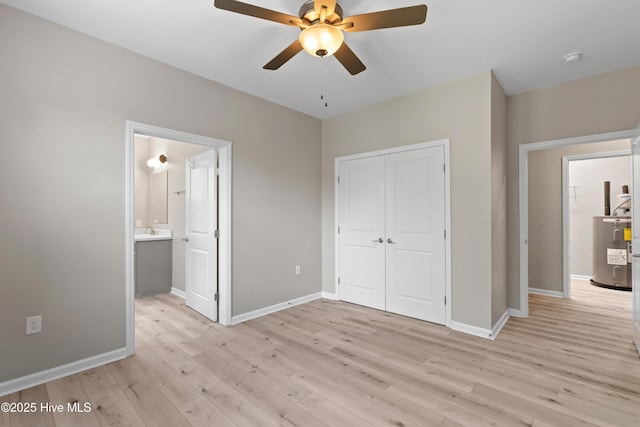 218 Spring Dr, Jacksonville, NC 28540 - unfurnished bedroom featuring water heater, light wood-style floors, a closet, and baseboards