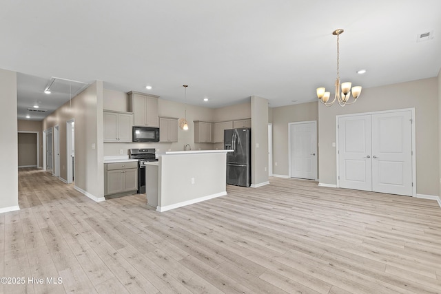 218 Spring Dr, Jacksonville, NC 28540 - kitchen featuring black microwave, fridge with ice dispenser, gray cabinets, stainless steel stove, and light wood-type flooring