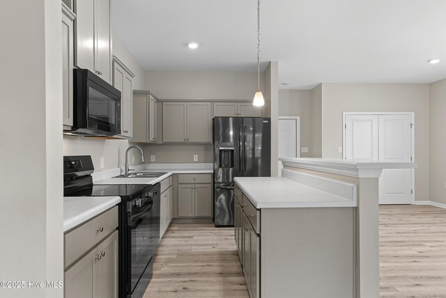 218 Spring Dr, Jacksonville, NC 28540 - kitchen with black appliances, gray cabinets, a sink, light wood-type flooring, and recessed lighting