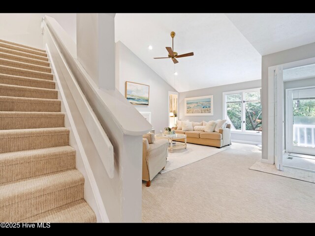 316 Wimbledon Ct, Wilmington, NC 28412 - carpeted living room with a textured ceiling, vaulted ceiling, baseboards, and a ceiling fan