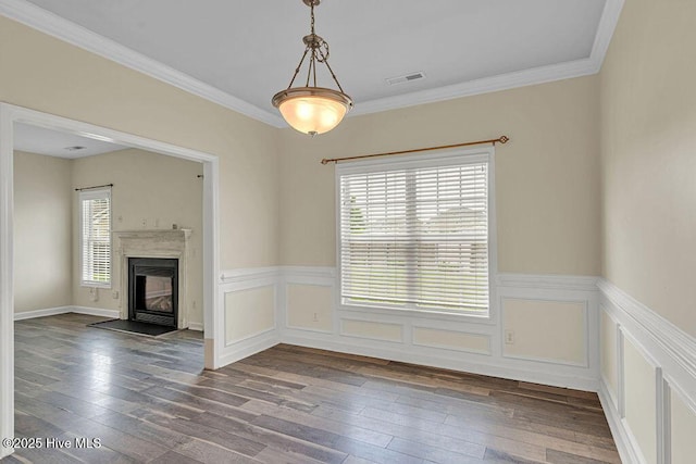 127 Moonstone Ct, Jacksonville, NC 28546 - unfurnished living room with hardwood / wood-style flooring, a wainscoted wall, a fireplace with flush hearth, and crown molding