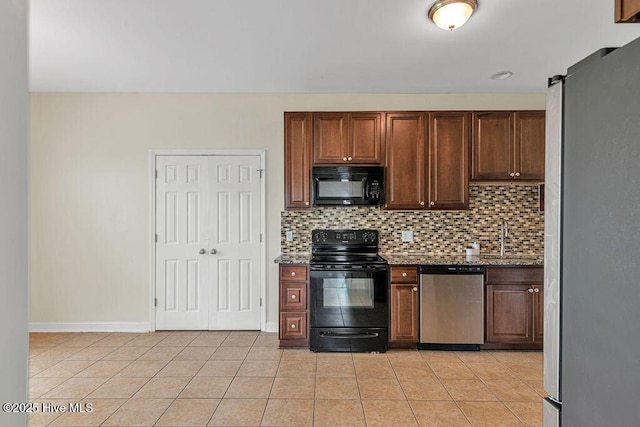127 Moonstone Ct, Jacksonville, NC 28546 - kitchen with black appliances, backsplash, light tile patterned floors, and light stone countertops