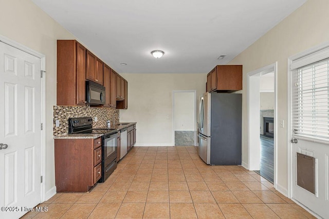 127 Moonstone Ct, Jacksonville, NC 28546 - kitchen featuring black appliances, decorative backsplash, baseboards, and light tile patterned floors