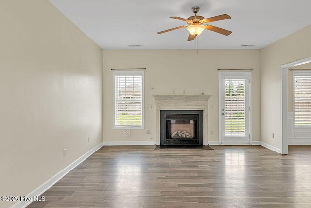 127 Moonstone Ct, Jacksonville, NC 28546 - unfurnished living room with hardwood / wood-style floors, ceiling fan, a fireplace with flush hearth, and baseboards